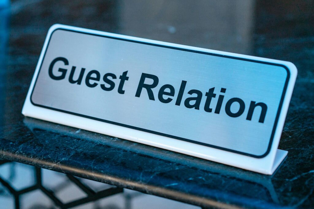 Co to znaczy PR i jak wpływa na marketing? Co to znaczy PR – tabliczka Guest Relation symbolizująca public relations i budowanie relacji z klientami oraz wizerunku marki